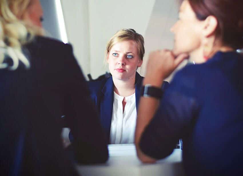 three women sitting beside table.jpg